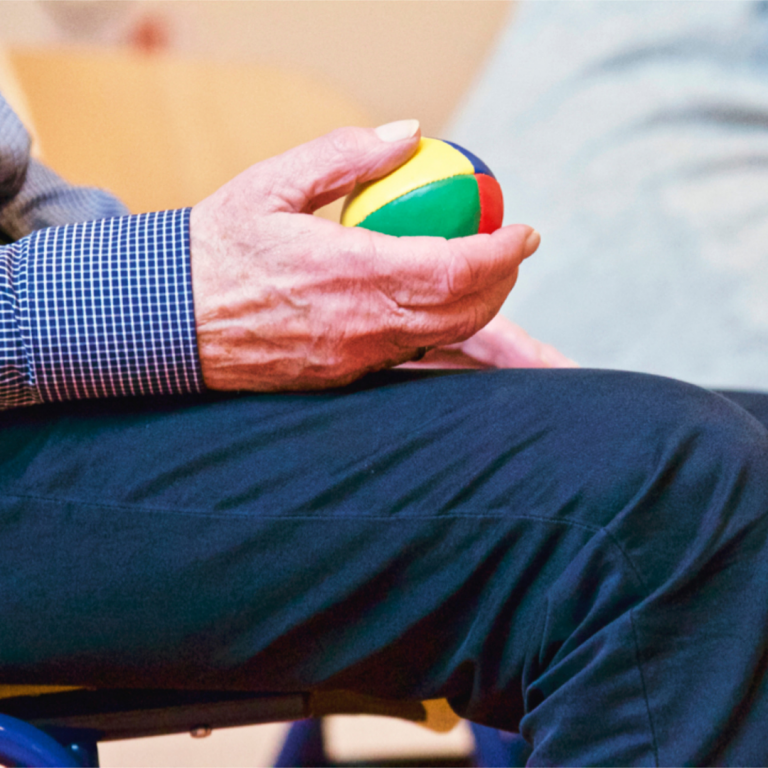 An elderly person holding something in their hand after a fall