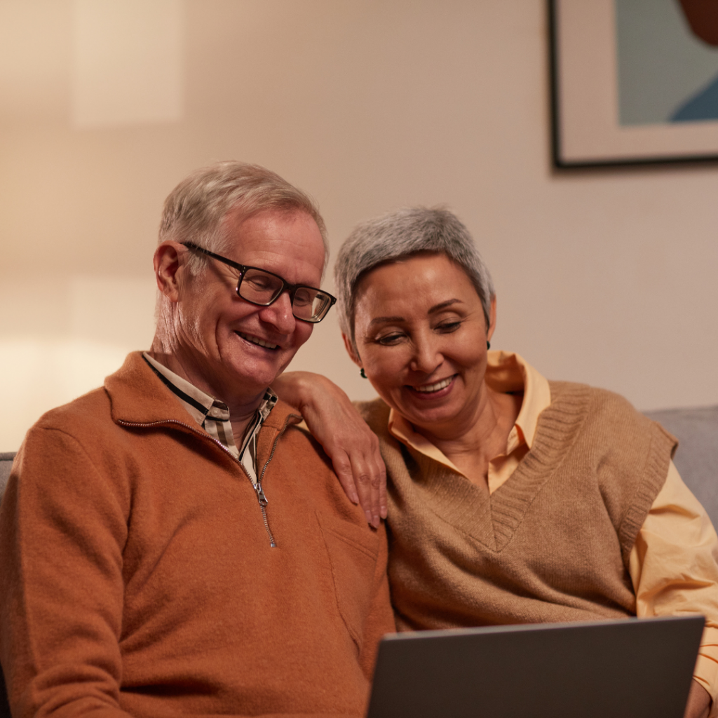 An elderly couple smiling because they gained their independence with technology